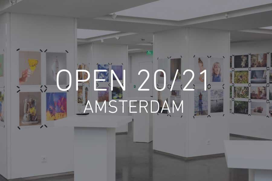 Image of the OPEN 2018 Amsterdam exhibition, with Newspaper Club prints taped to walls and pillars at 5&33 Gallery, with text reading 'OPEN 20/21 AMSTERDAM' in the centre