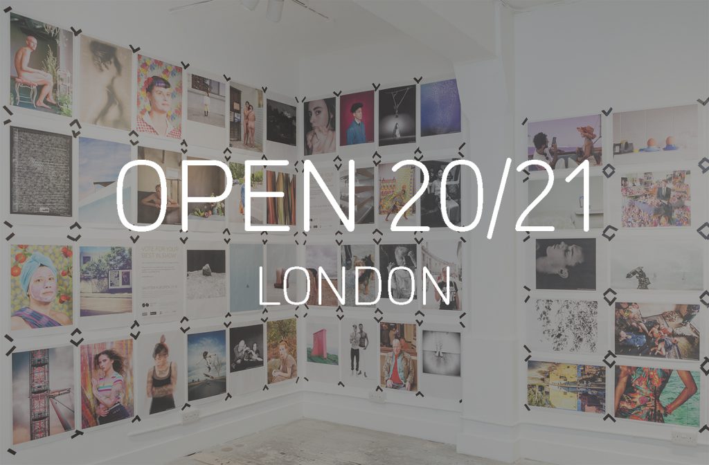 Graphic with a photograph of newspaper poster printed photographs displayed taped to the walls at London's Old Truman Brewery, with the words 'OPEN 20/21, London' in white in the centre