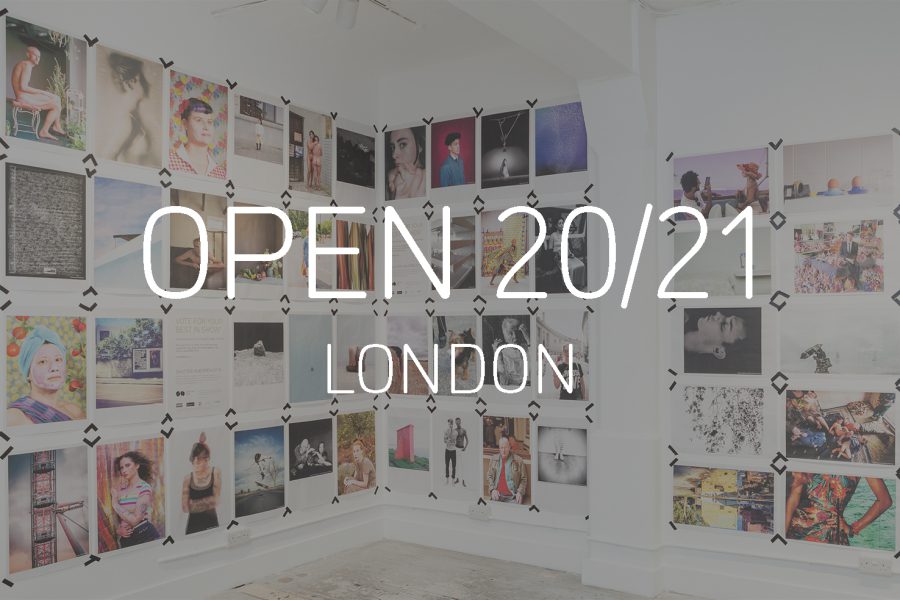 Graphic with a photograph of newspaper poster printed photographs displayed taped to the walls at London's Old Truman Brewery, with the words 'OPEN 20/21, London' in white in the centre
