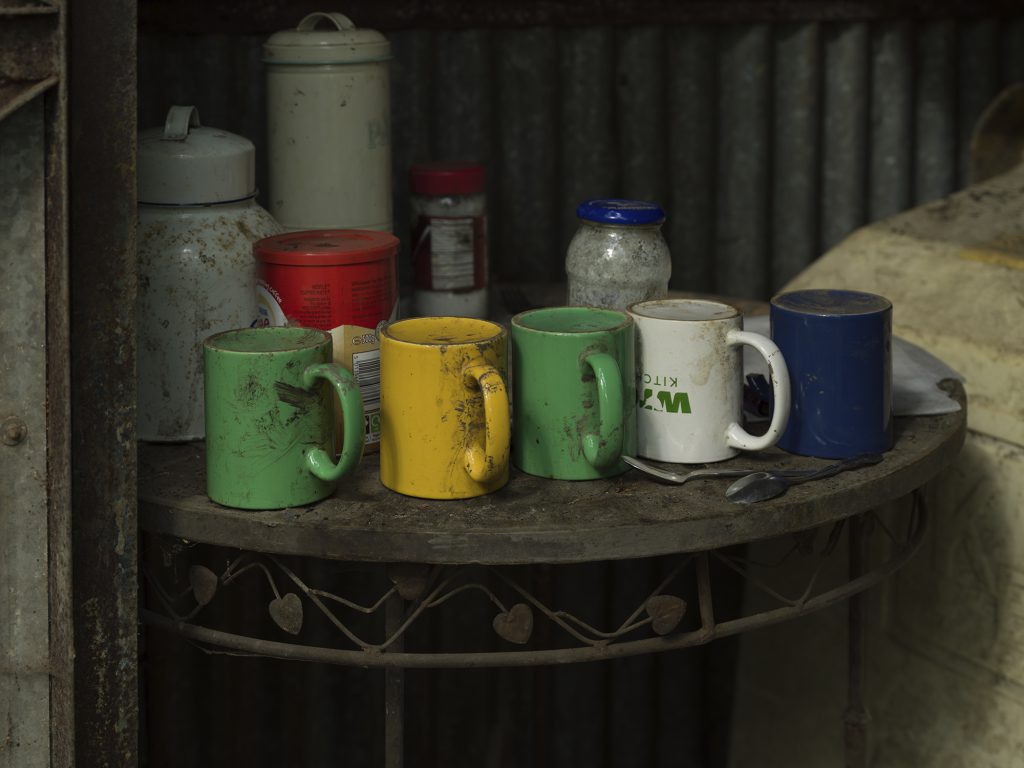 Tea mugs lined up on table