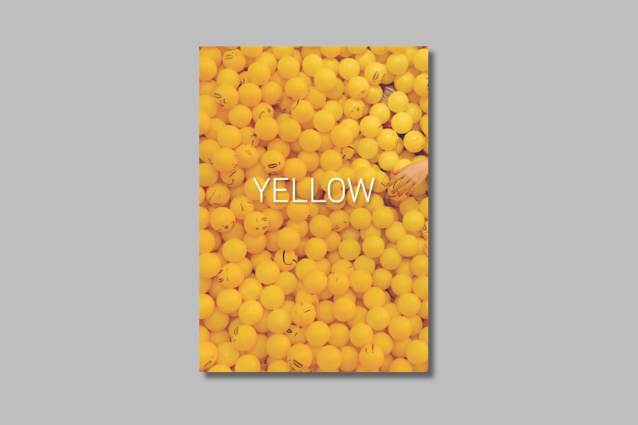 YELLOW photobook cover with image of ballpit filled with yellow plastic balls, and a hand reaches into the pit.